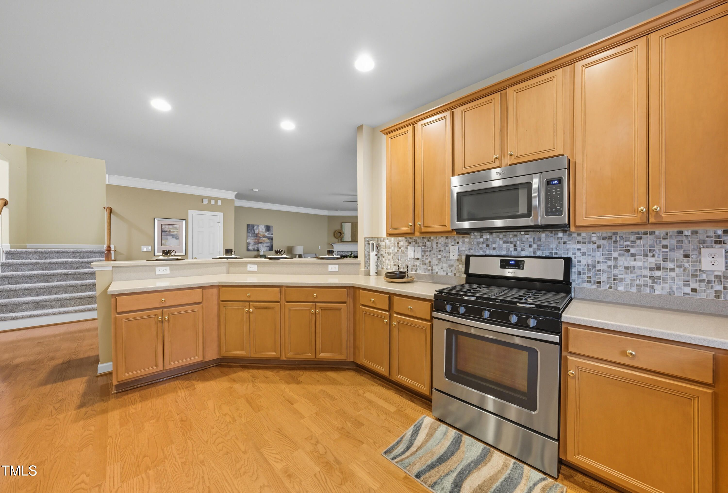 5210 Rio Grande Drive Raleigh, NC 27616 - Photo 14 of 45 a kitchen with a stove a sink and a microwave