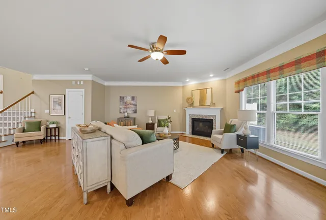 a living room with furniture large window and a fireplace