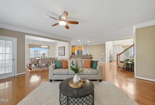 a living room with fireplace furniture and a wooden floor