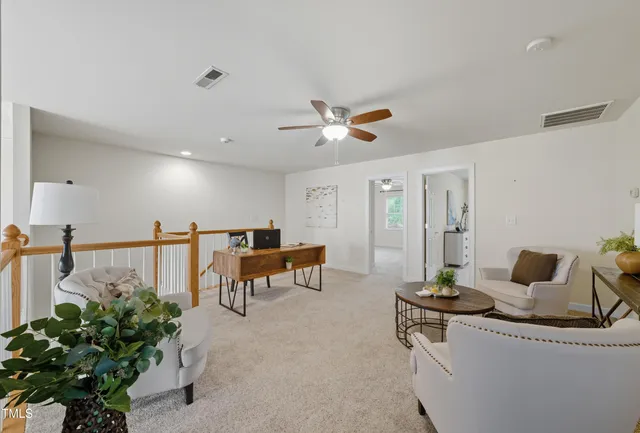a living room with furniture and potted plant