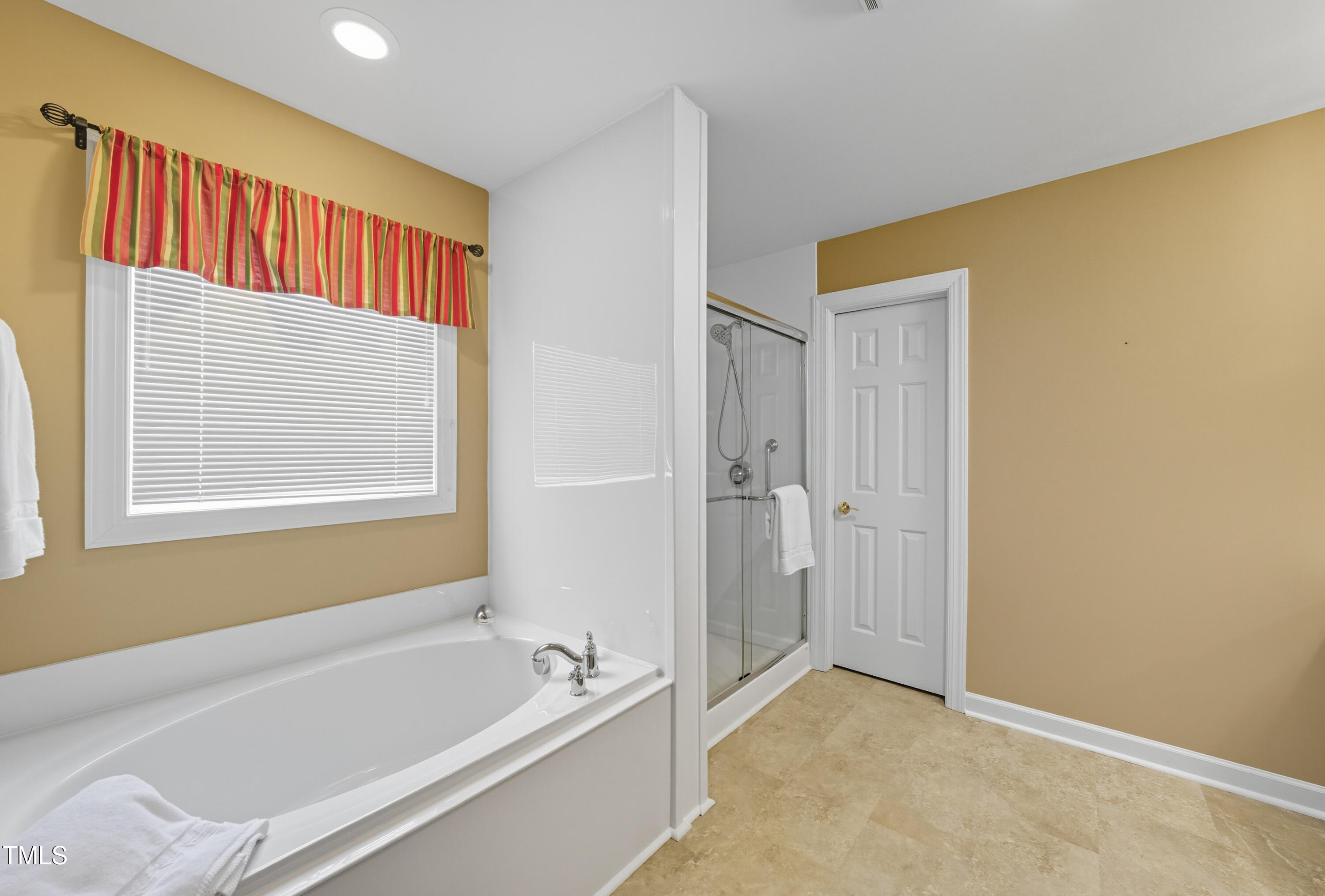 5210 Rio Grande Drive Raleigh, NC 27616 - Photo 32 of 45 a bathroom with a tub and a shower
