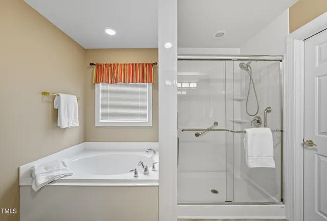 a bathroom with a bathtub and a shower