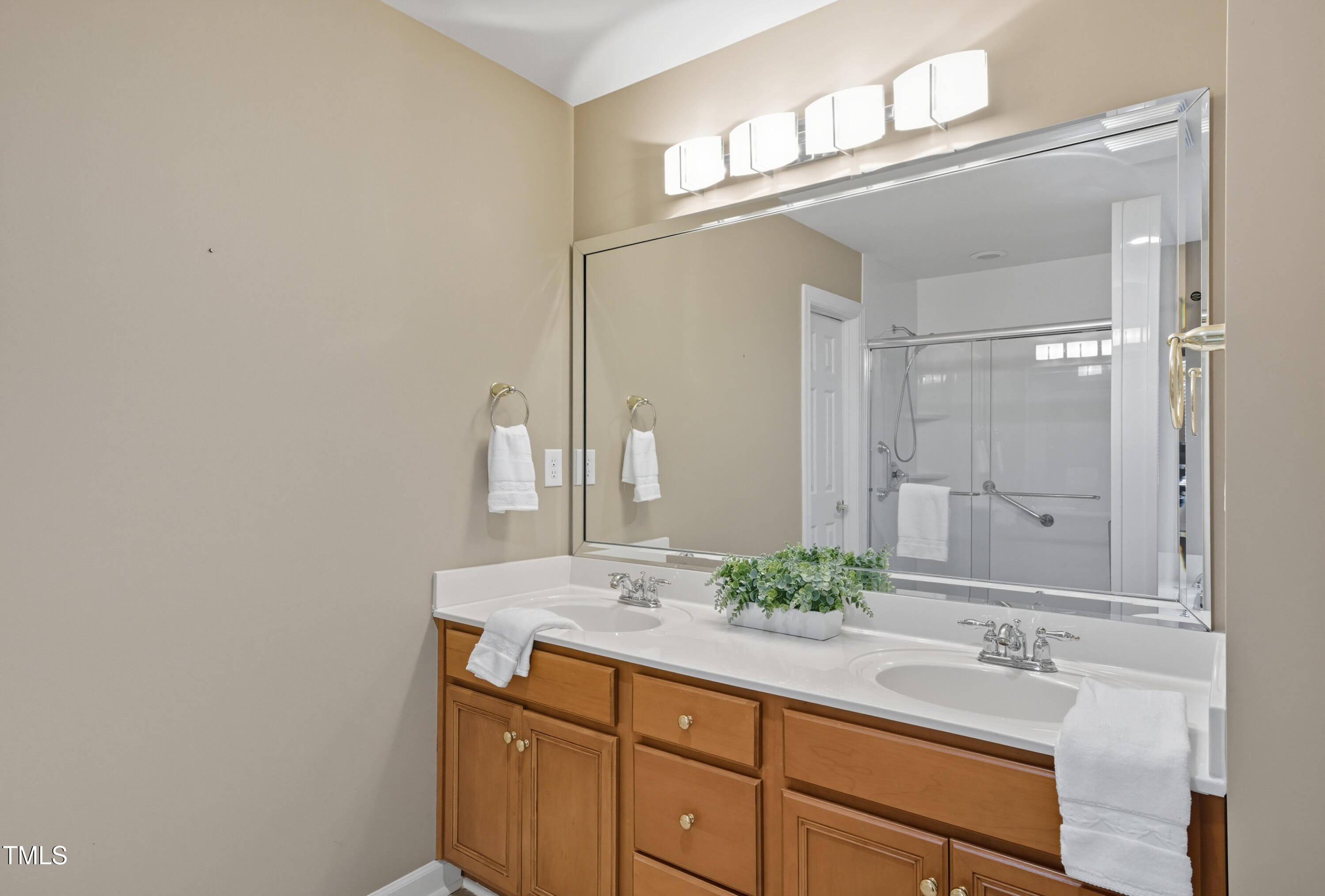 5210 Rio Grande Drive Raleigh, NC 27616 - Photo 34 of 45 a bathroom with a granite countertop sink and a mirror