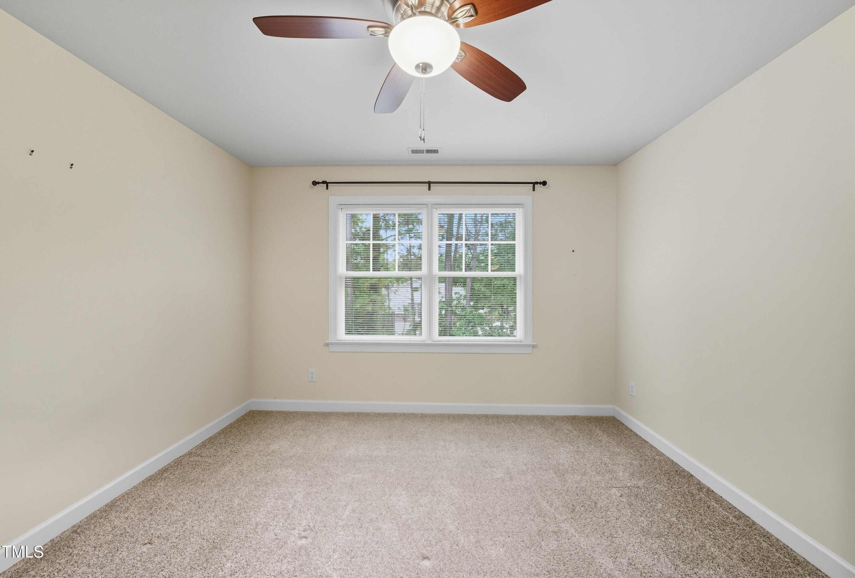5210 Rio Grande Drive Raleigh, NC 27616 - Photo 37 of 45 an empty room with a chandelier fan and windows