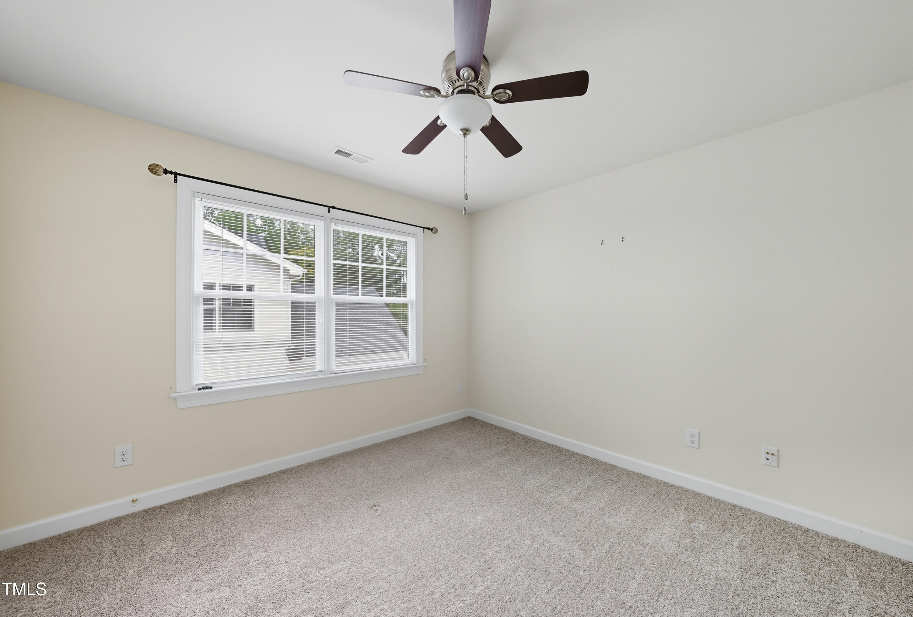 5210 Rio Grande Drive Raleigh, NC 27616 - Photo 38 of 45 an empty room with a window and a fan