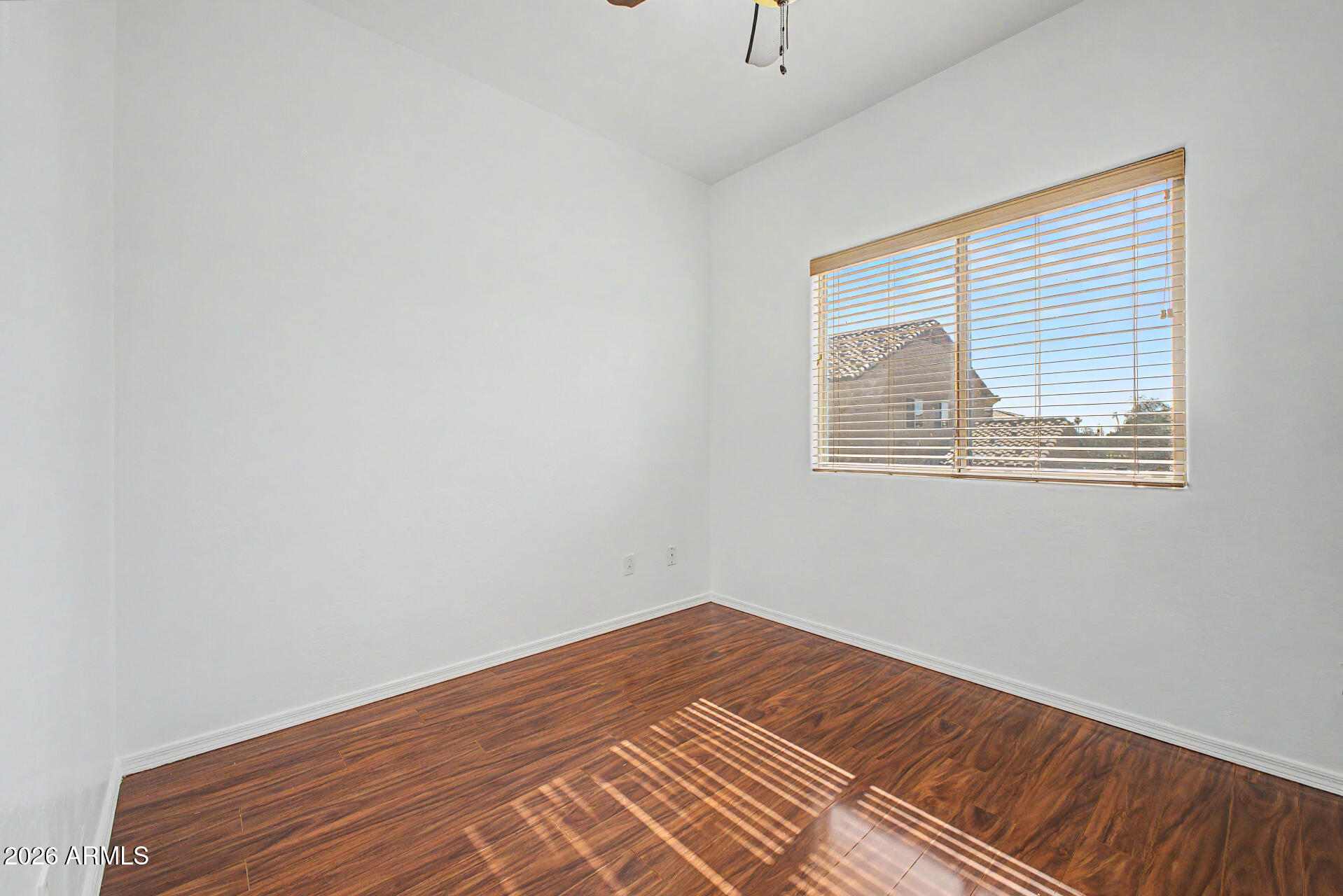 7206 South 12th Way Phoenix, AZ 85042 - Photo 21 of 34 a view of a room with wooden floor and a window