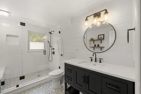 a bathroom with a toilet sink and shower