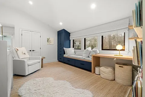 a bedroom with furniture and a large window