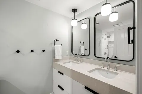 a bathroom with a double vanity sink mirror and double