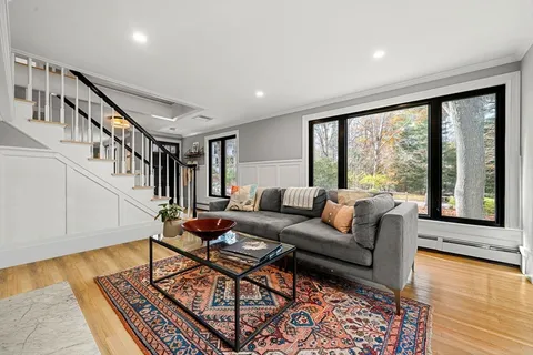 a living room with furniture and a table with wooden floor