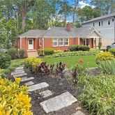 a front view of a house with a garden