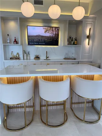 a living room with furniture a ceiling fan wooden floor and a large window