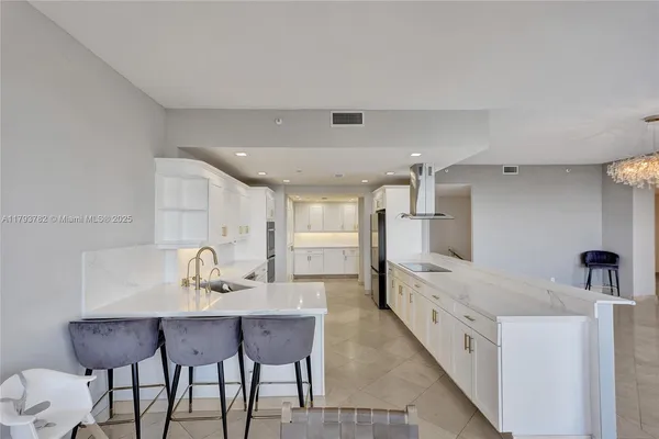 a dining room with furniture and chandelier