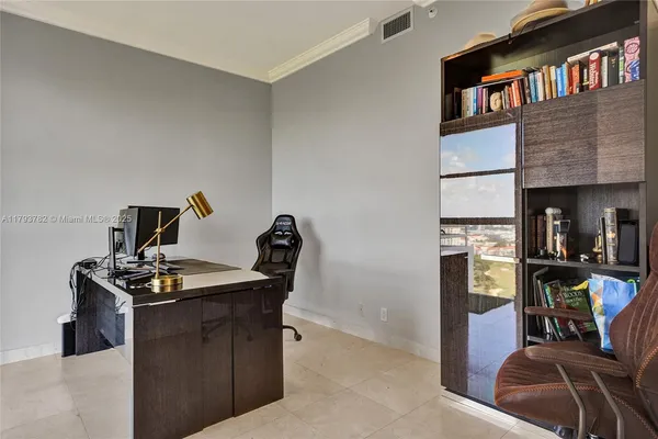 a bedroom with a bed and glass door