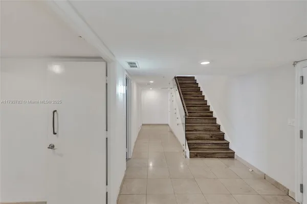 a bathroom with a granite countertop sink a mirror and a shower