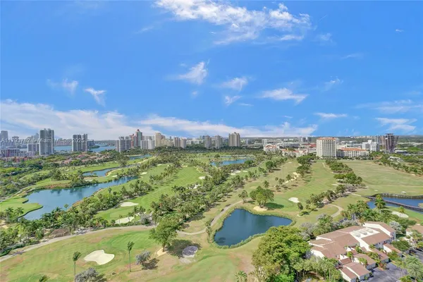 a living room with fireplace furniture and a floor to ceiling window
