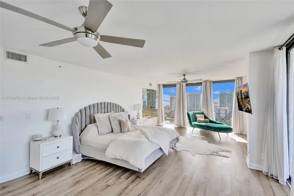 a bedroom with furniture and a large window