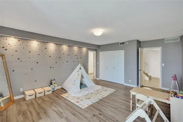 a spacious bathroom with a double vanity sink a large mirror and shower