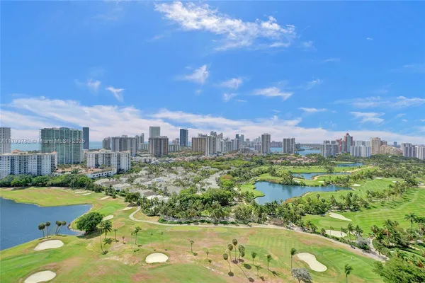 a bedroom with a bed and a view of living room