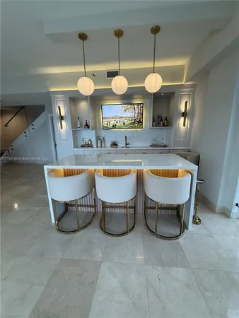 a living room with furniture a flat screen tv and white walls
