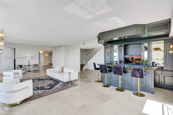 a view of a hallway with wooden floor and cabinets