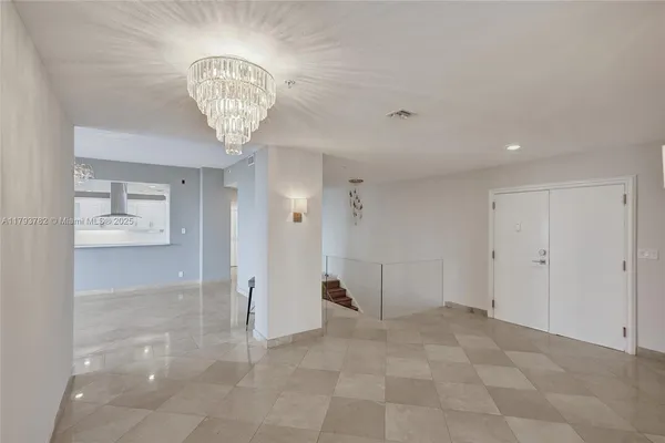 a large kitchen with a table and chairs