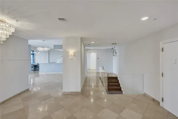 a large kitchen with a table and chairs