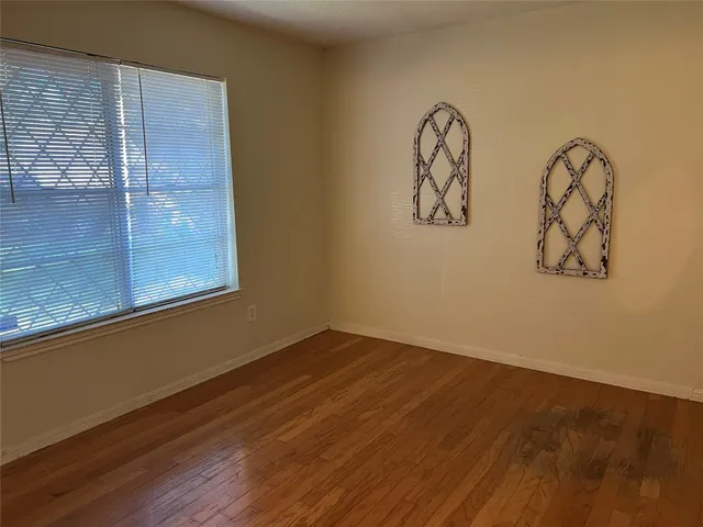 a view of water heater room with wooden floor