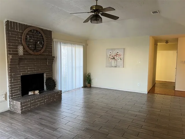 a view of a livingroom with a fireplace and window