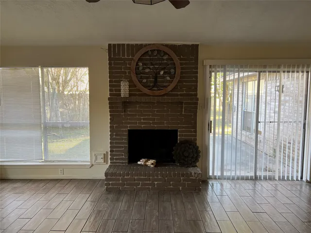 a living room with a fireplace and a wooden floor