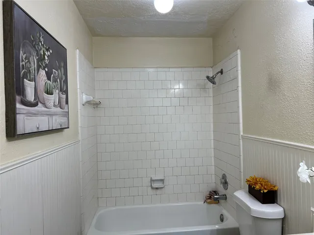 a bathroom with a bathtub and toilet