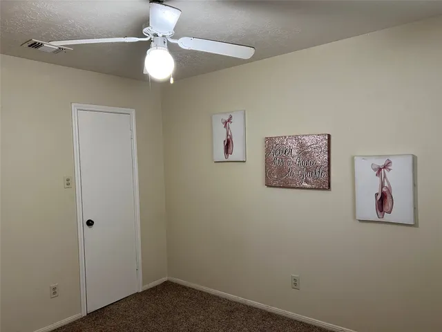 an empty room with a painting on the wall