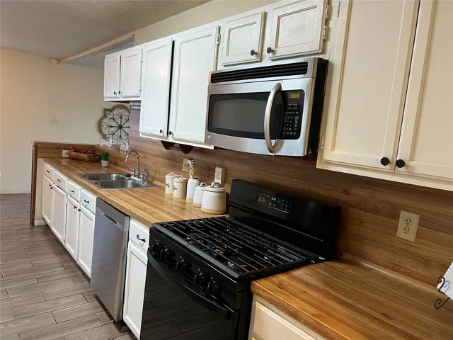 a kitchen with stainless steel appliances granite countertop a stove and a microwave