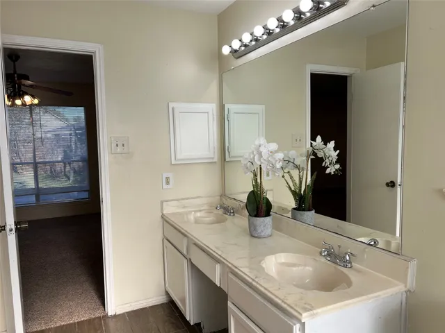 a bathroom with a sink double vanity and a mirror