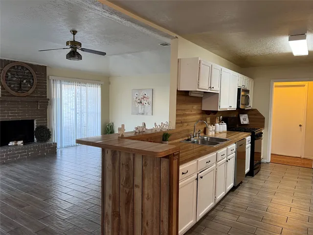 a kitchen with stainless steel appliances granite countertop a stove sink and cabinets