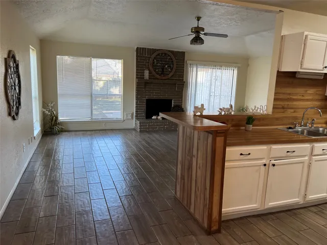 a kitchen with granite countertop a stove a sink and a refrigerator