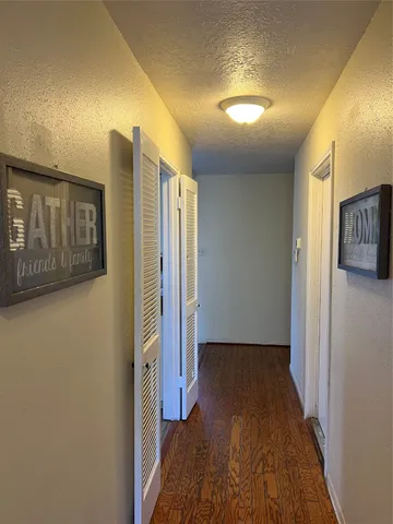 a view of a hallway with entryway door