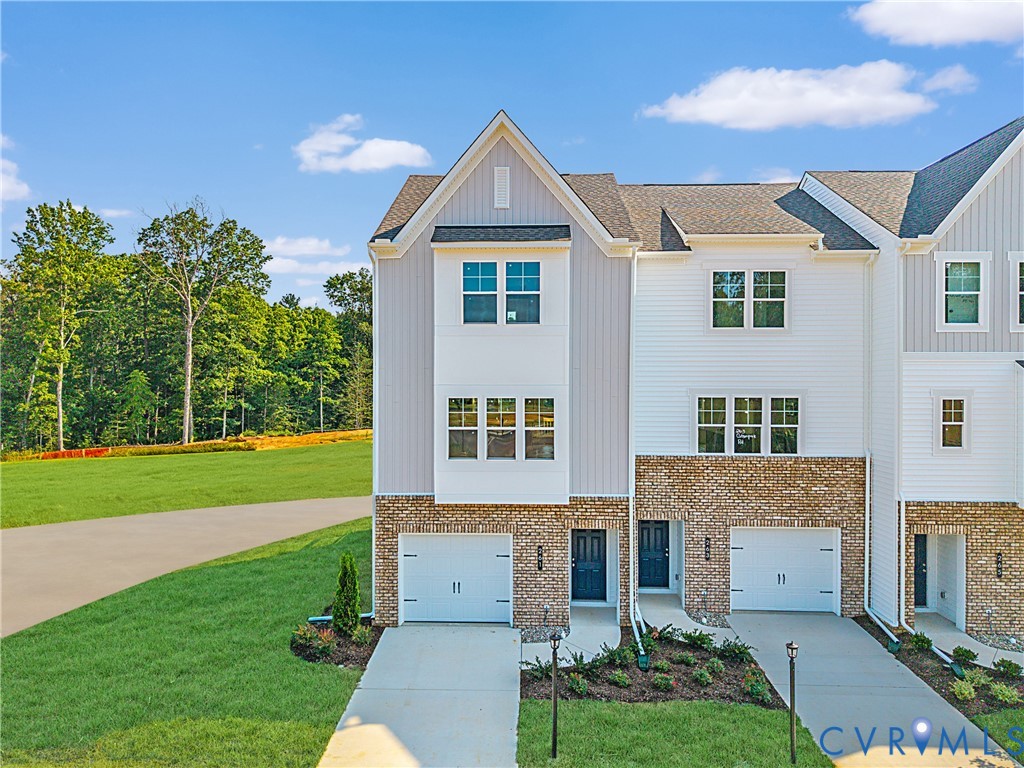 a front view of a house with a garden