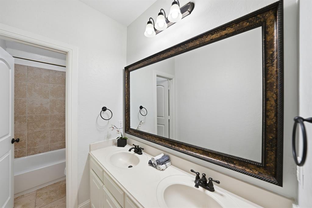624 Sorrell Road McKinney, TX 75072 - Photo 24 of 28 a bathroom with a sink and a mirror