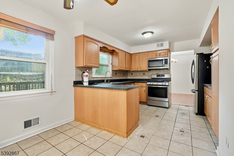 30 Brookside Road Edison, NJ 08817 - Photo 7 of 18 a kitchen with stainless steel appliances granite countertop a stove a sink and a refrigerator