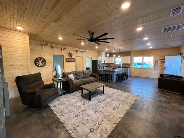 a living room with furniture and kitchen view