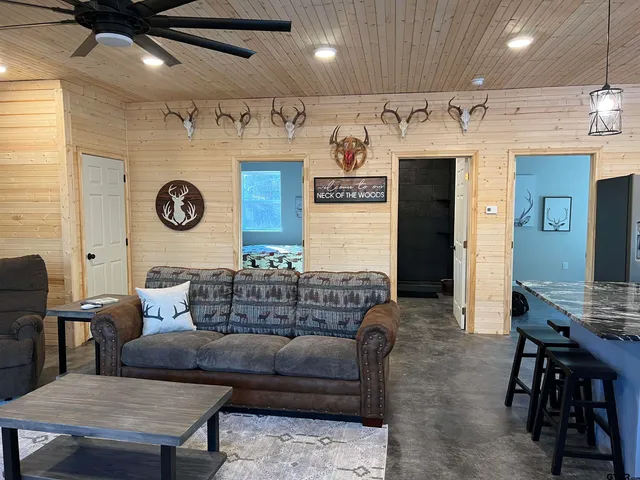a living room with furniture and kitchen view