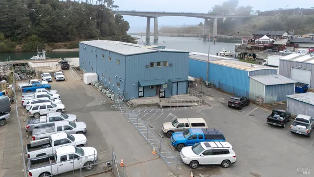 a living room with furniture and a kitchen