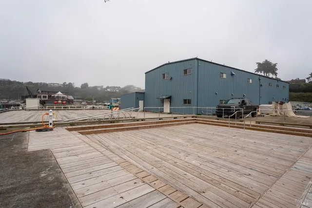 a room with a refrigerator and a workspace