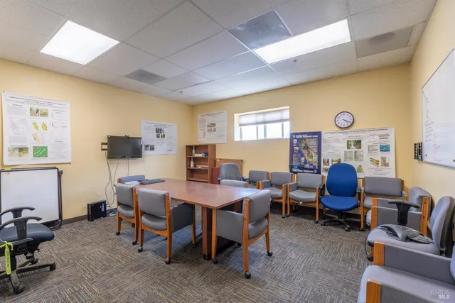 a view of a balcony with chairs and wooden floor