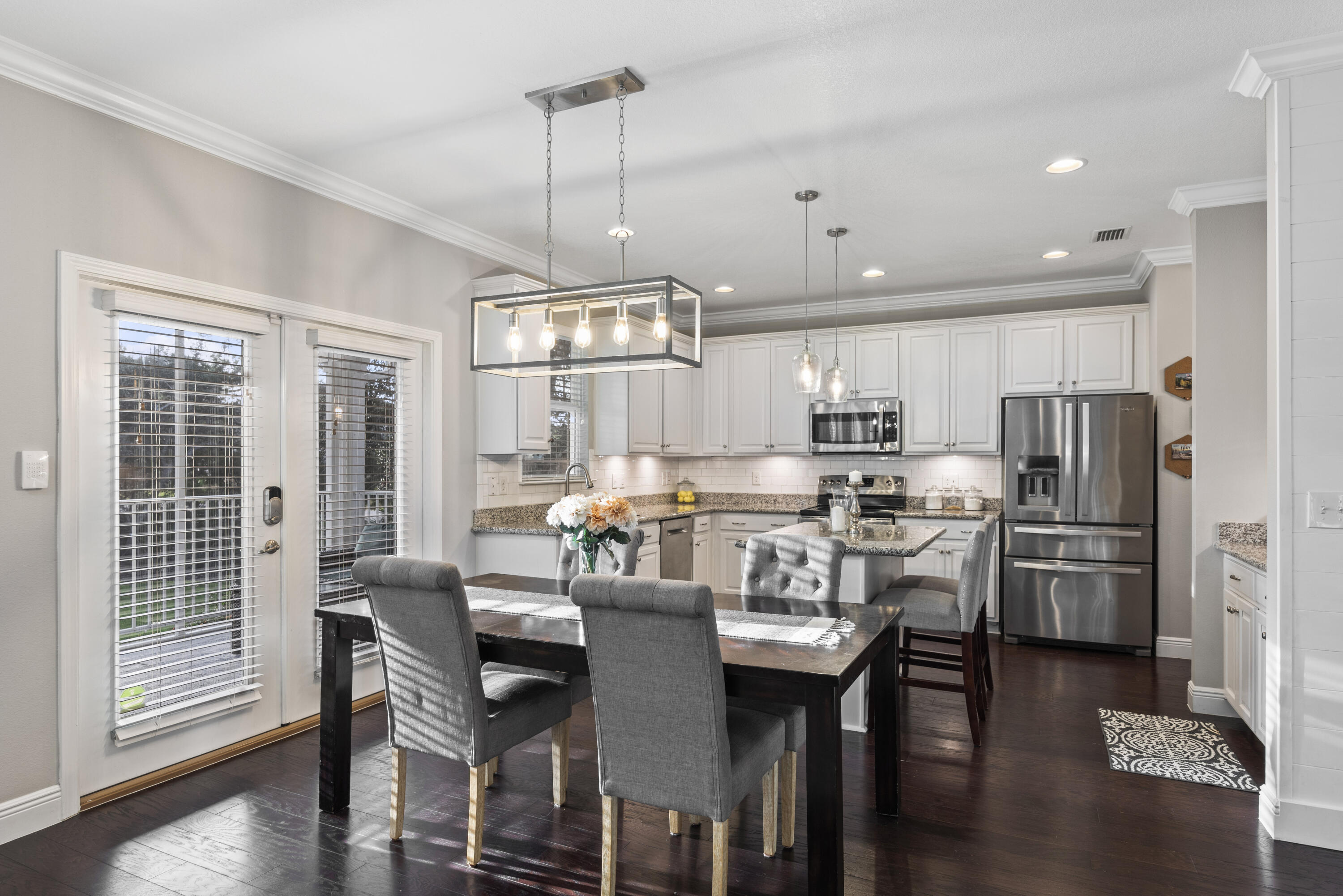 1584 Driftwood Point Road Santa Rosa Beach, FL 32459 - Photo 21 of 50 a kitchen with stainless steel appliances a dining table chairs refrigerator and microwave