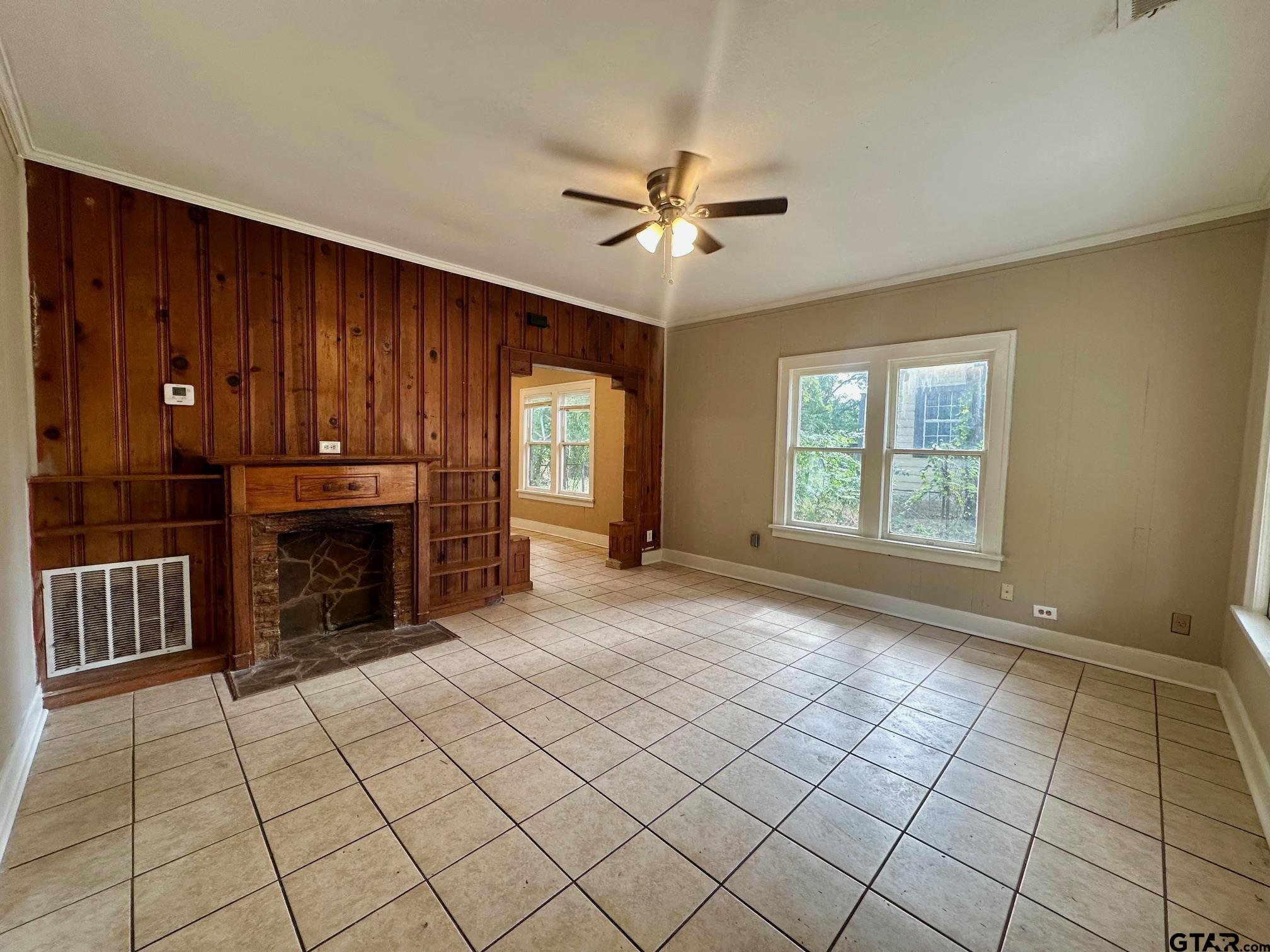 1102 Myrtle Street Kilgore, TX 75662 - Photo 2 of 9 a view of an empty room with window and chandelier fan
