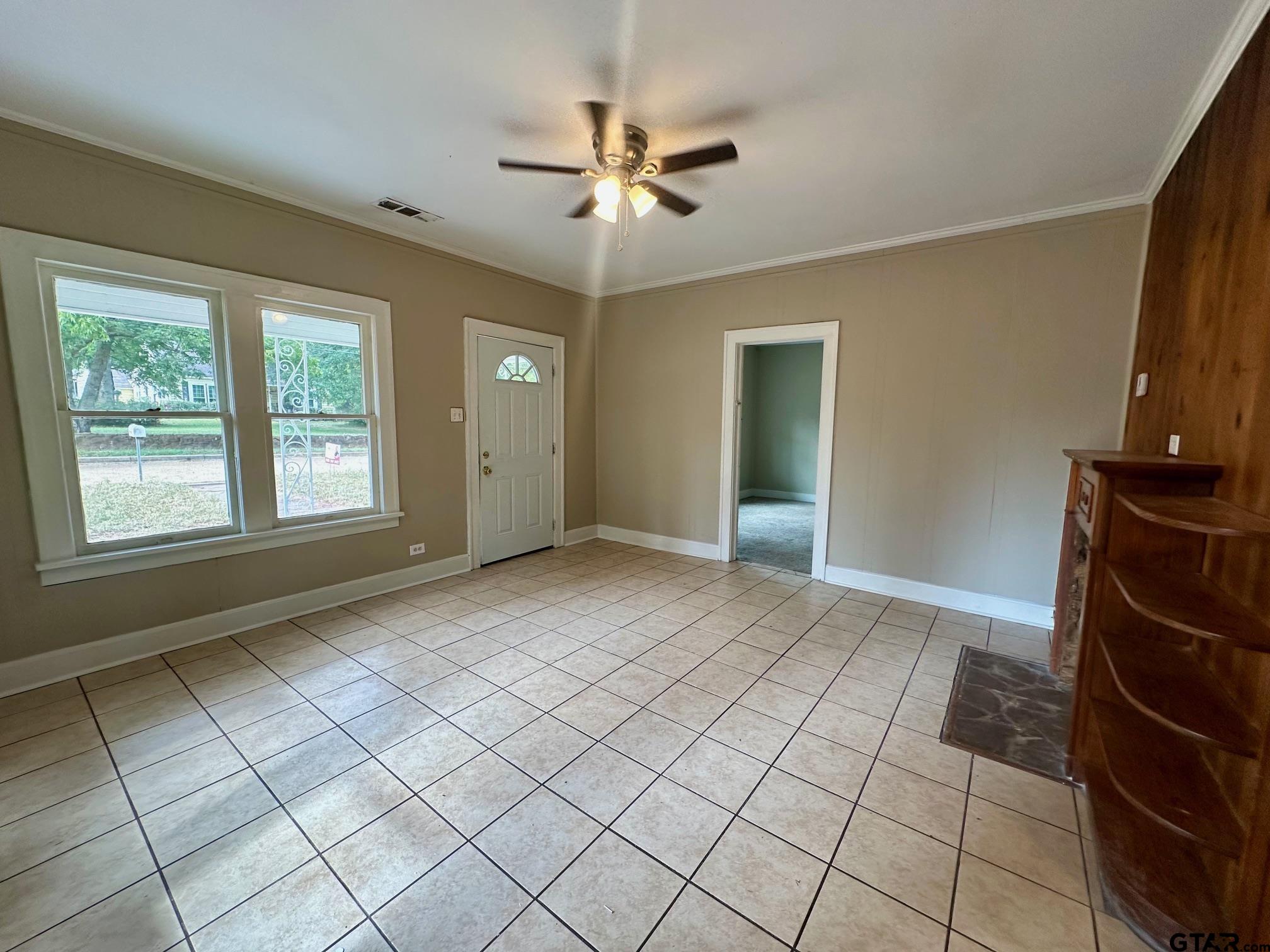 1102 Myrtle Street Kilgore, TX 75662 - Photo 3 of 9 a view of an empty room with a window