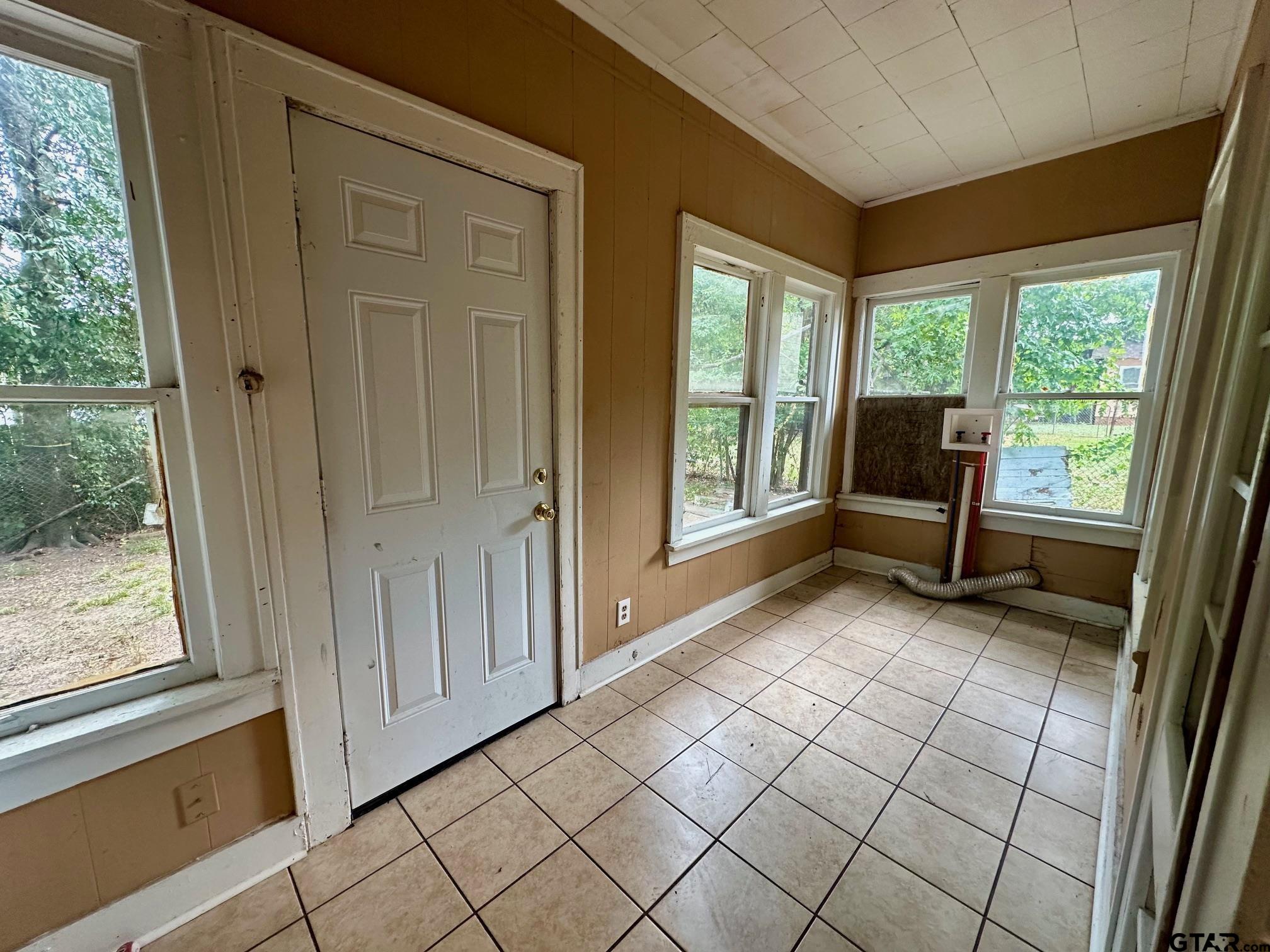 1102 Myrtle Street Kilgore, TX 75662 - Photo 6 of 9 a view of an empty room with wooden floor and a window