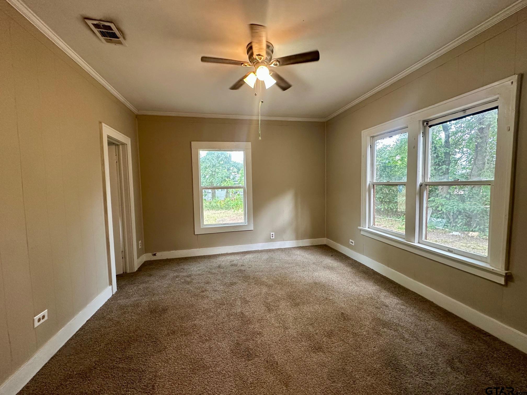 1102 Myrtle Street Kilgore, TX 75662 - Photo 7 of 9 a view of an empty room with a window